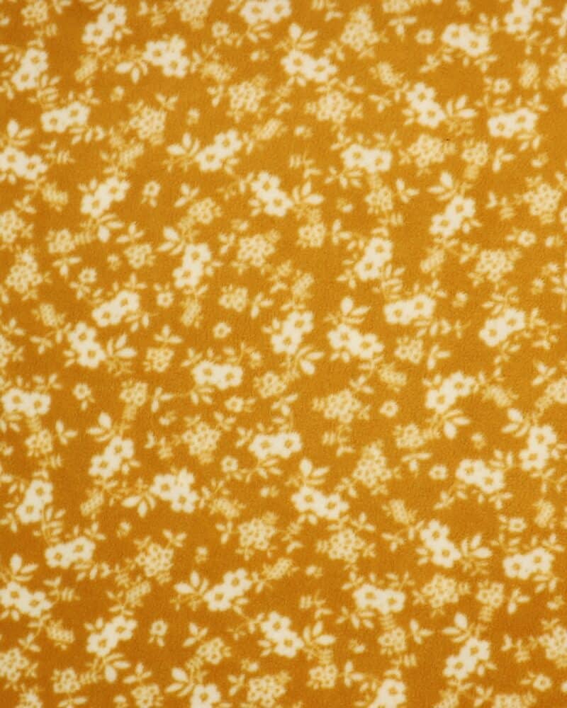 Hvide blomster på karryfarvet - Fleece - Info mangler