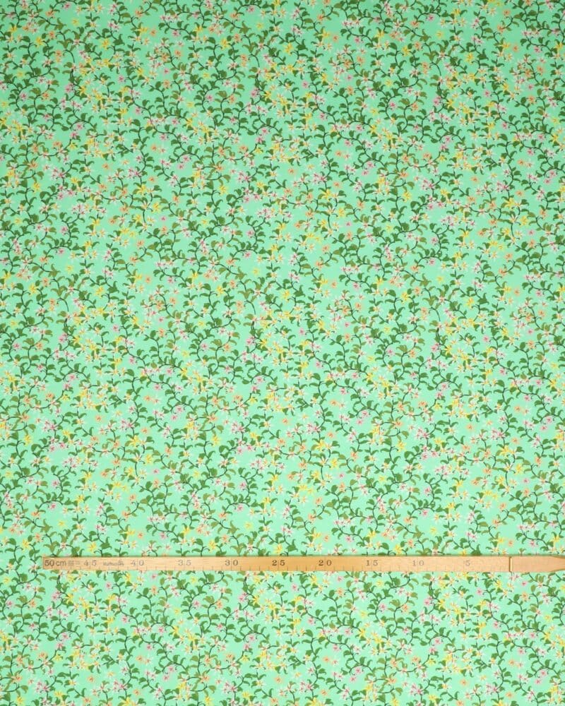 Blomstersnerler på lys grøn - Jersey - Stoffabrics