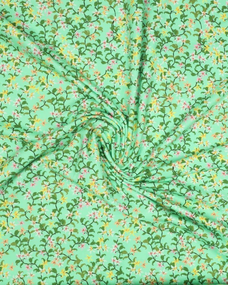 Blomstersnerler på lys grøn - Jersey - Stoffabrics